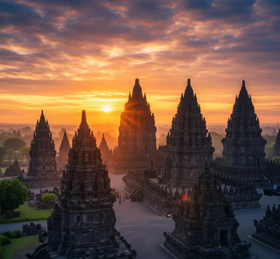 Pemandangan panorama Candi Prambanan yang megah saat fajar, disinari cahaya keemasan, memancarkan keagungan kuno dan keindahan mistis.